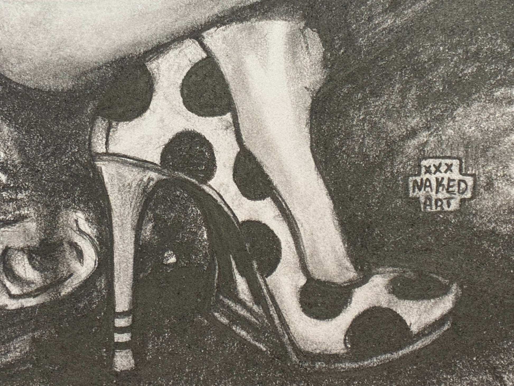 Black and white polka dot shoes with high heels on a textured background, featuring 'Naked Art' branding.