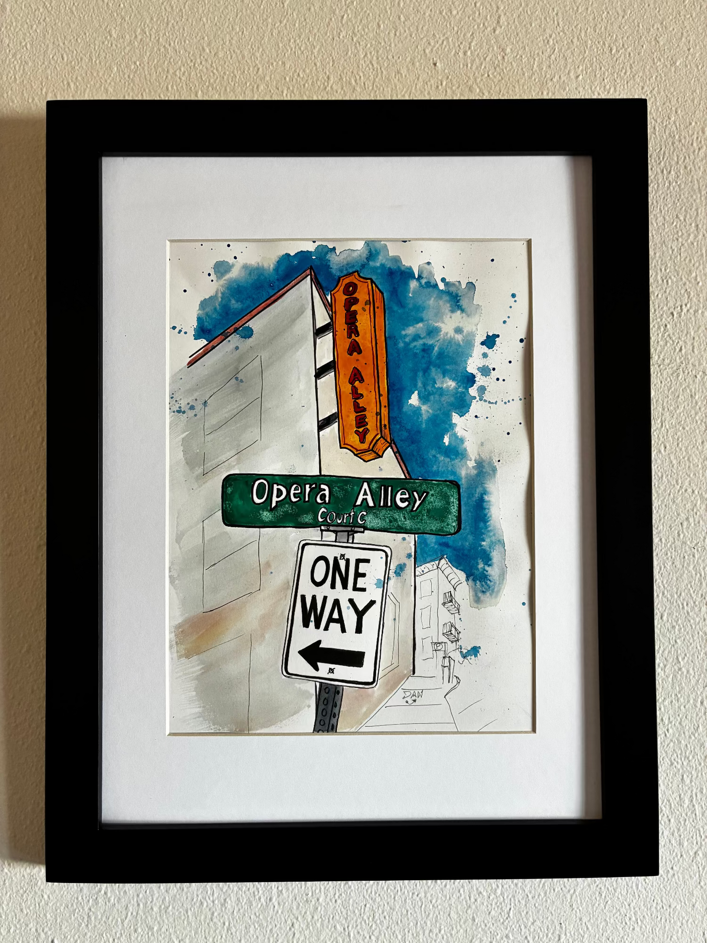 Framed artwork of street signs on a white wall