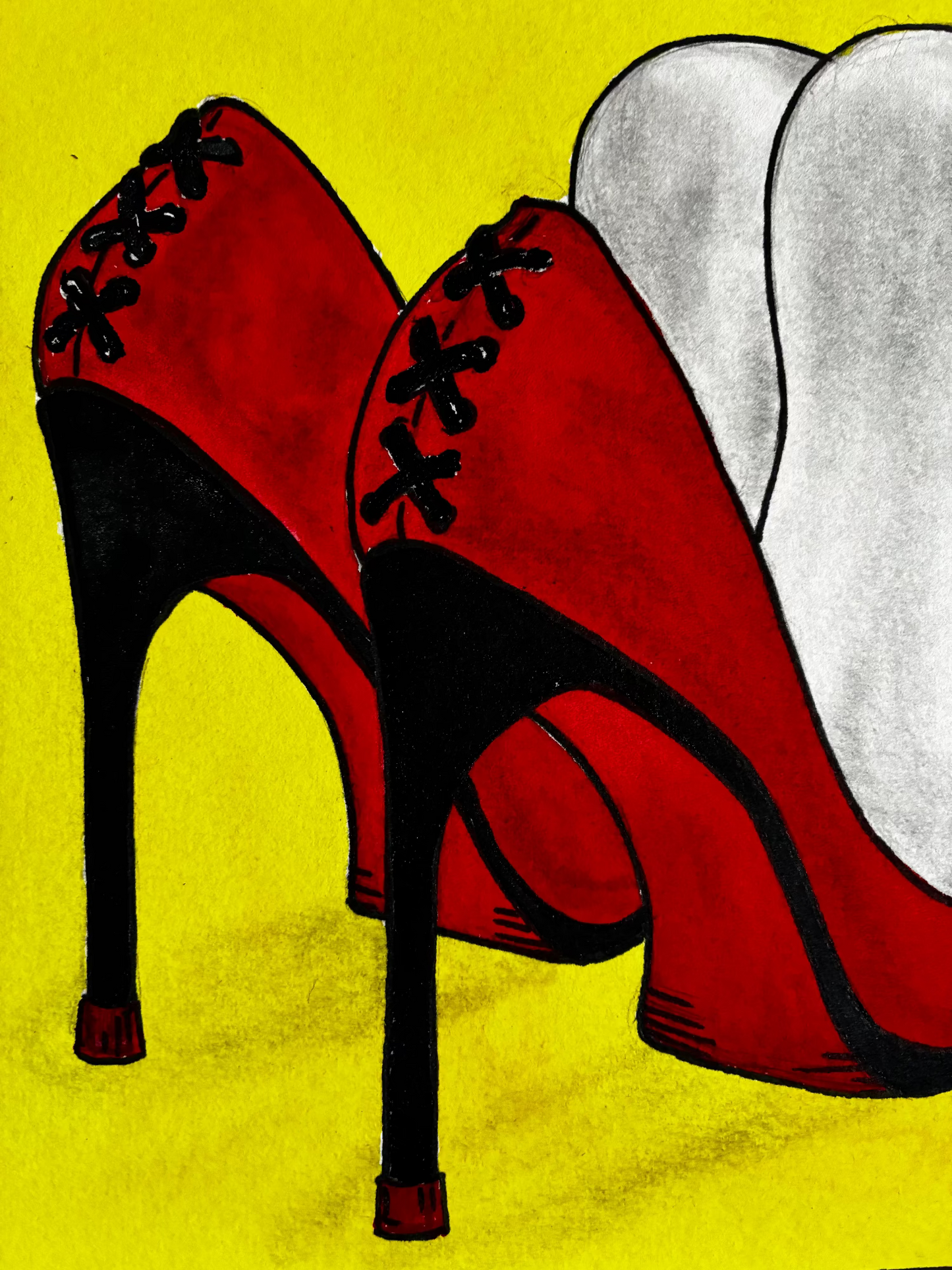 Red high-heeled shoes with black laces on a yellow background