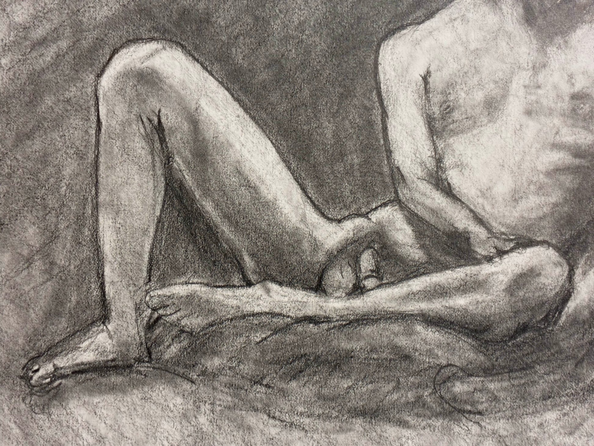 Pencil drawing of a nude figure sitting on the ground.
