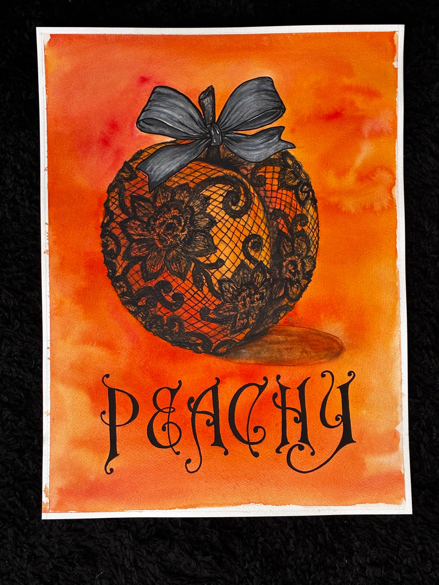 A watercolor-style art print featuring a peach decorated with black lace and a dark gray bow, with the word 'PEACHY' in ornate black lettering below. The artwork is centered on a black textured background.
