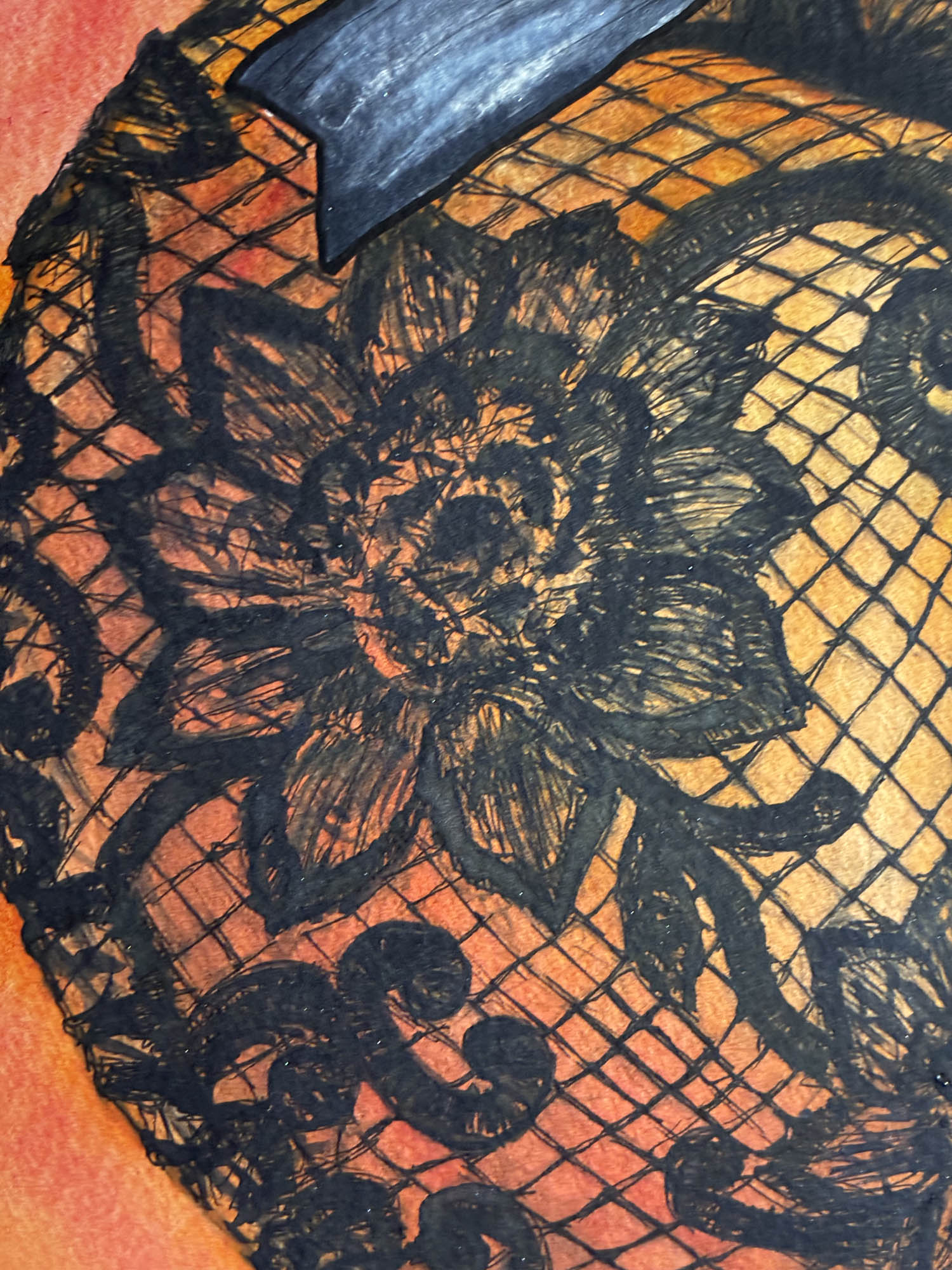 Black floral lace and fishnet fabric with a dark blue ribbon bow, laid over a textured orange and yellow background.