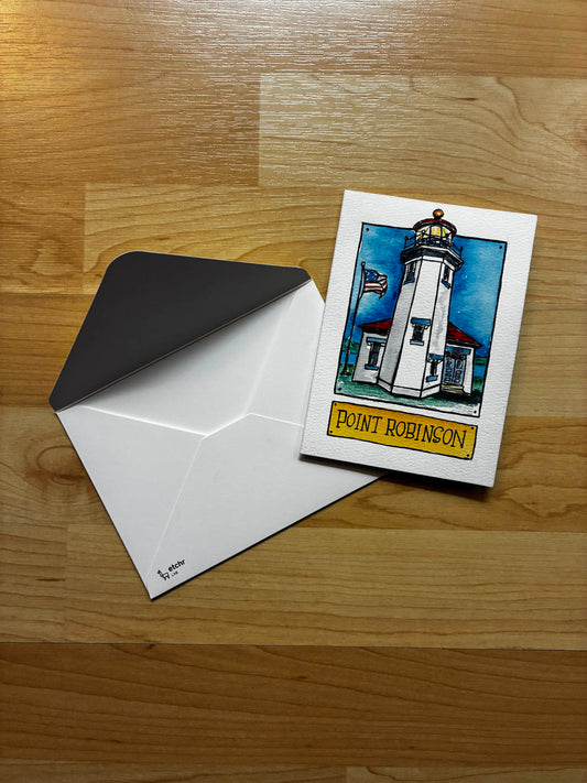 Greeting card with lighthouse illustration and envelope on a wooden surface