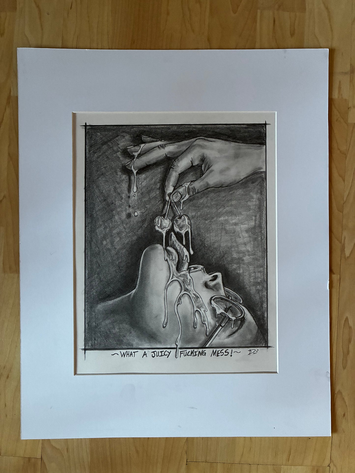 Matted black and white drawing of hands and a mouth on a wooden surface