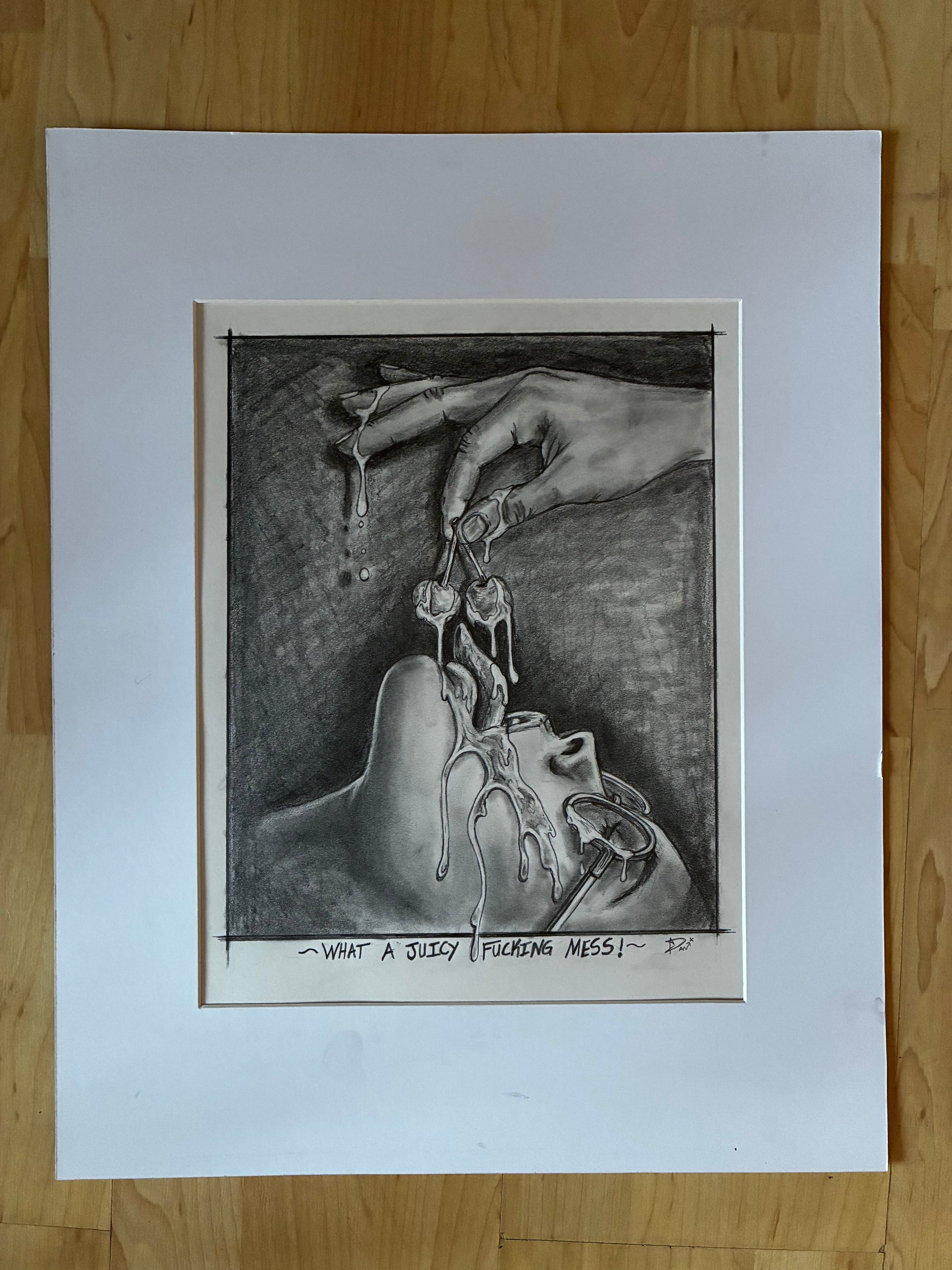 Matted black and white drawing of hands and a mouth on a wooden surface